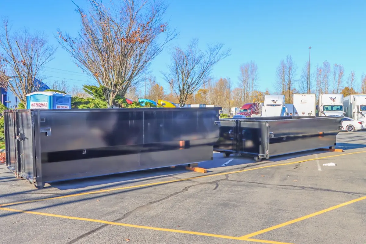 Professional dumpster rental service with roll-off container on residential driveway in Saratoga Springs